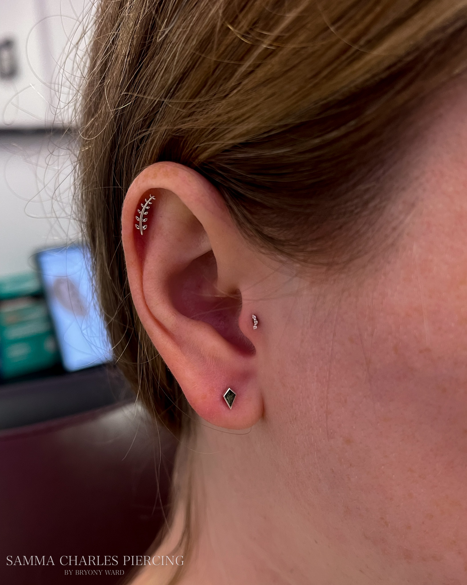 Three-piercing ear curation by Stab Daddy Bri