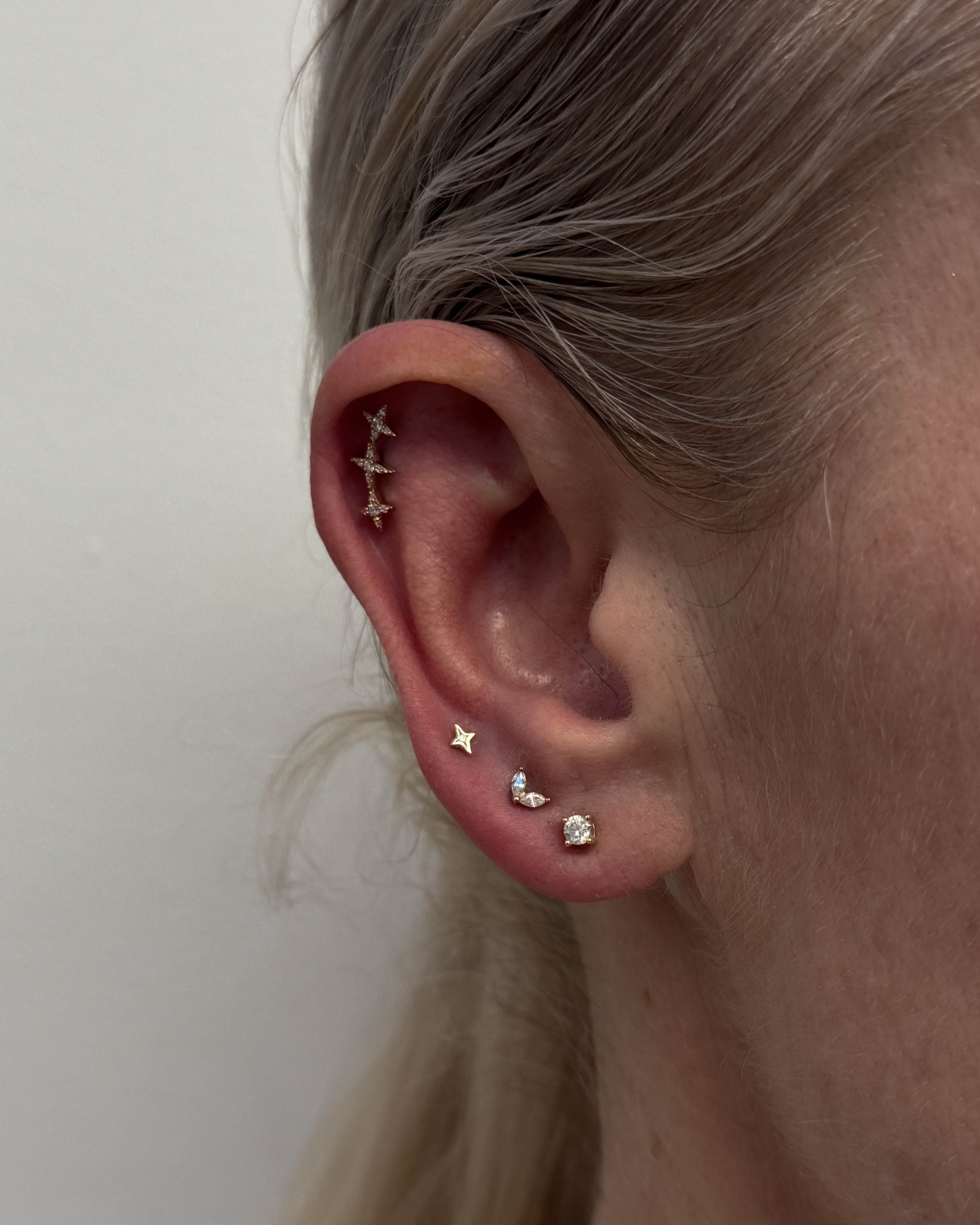 Curated ear with multiple piercings by Stab Daddy Bri, Oxford